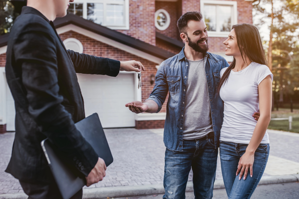 Realtor Giving Keys to the Couple